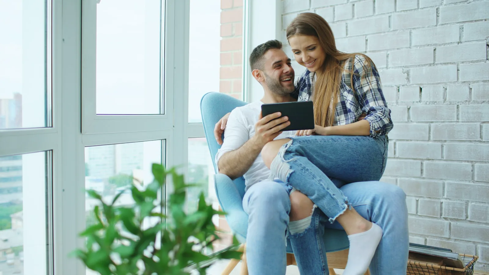 Couple consulting a tablet, illustrative image