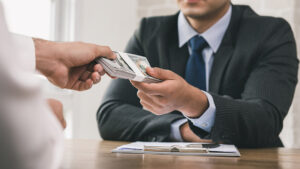 man receiving money in office